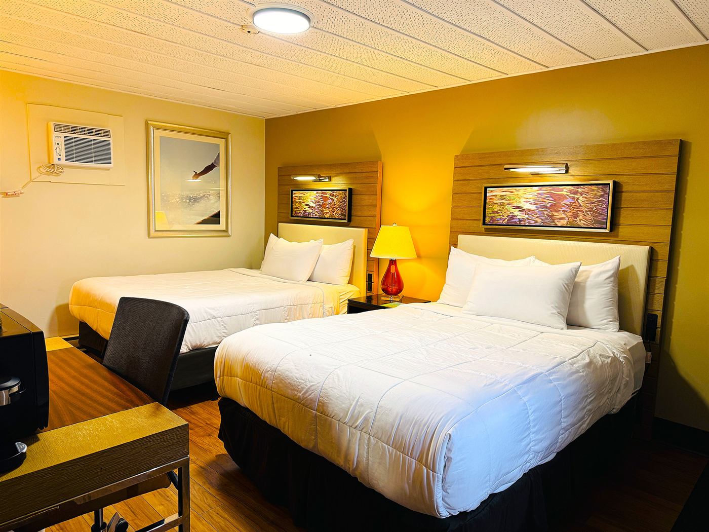 Double queen guest room with two beds and a work desk at Forest Inn Sioux Lookout
