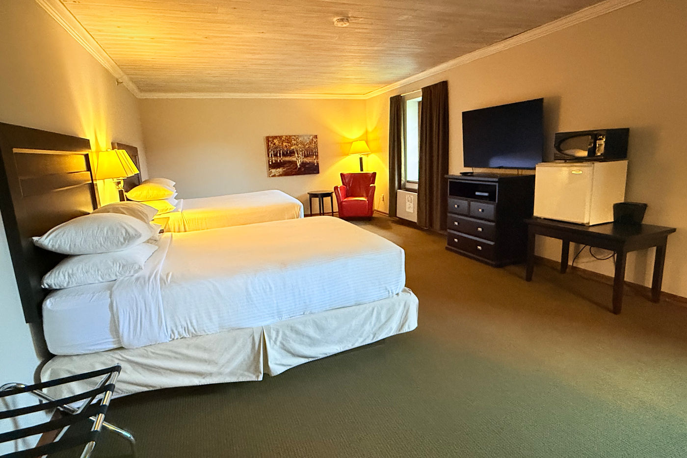 Executive room at The Riverview Lodge with two queen beds, a workspace, and a television